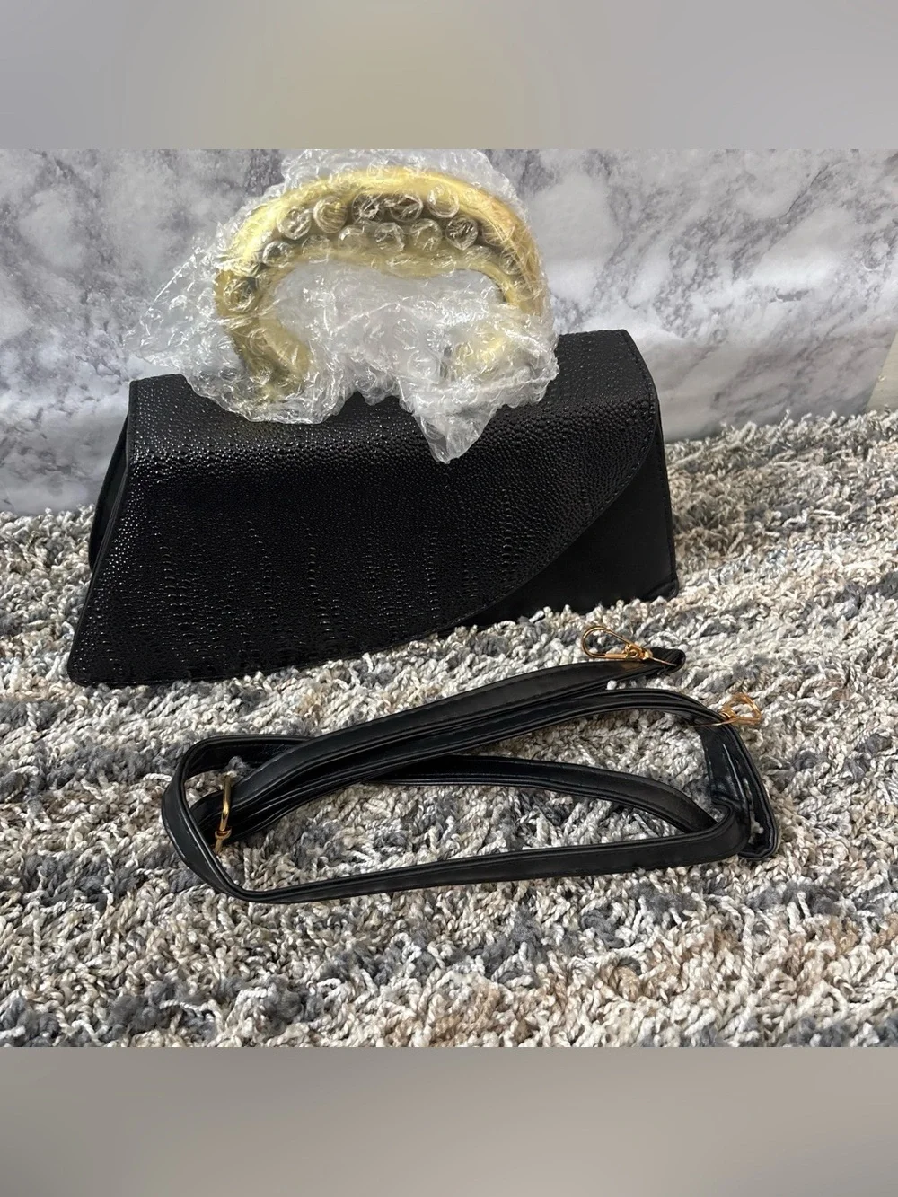 Elegant Black Textured Clutch with Gold Accent Handle